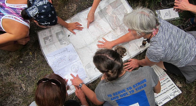 adults learn navigation skills on backpacking trip